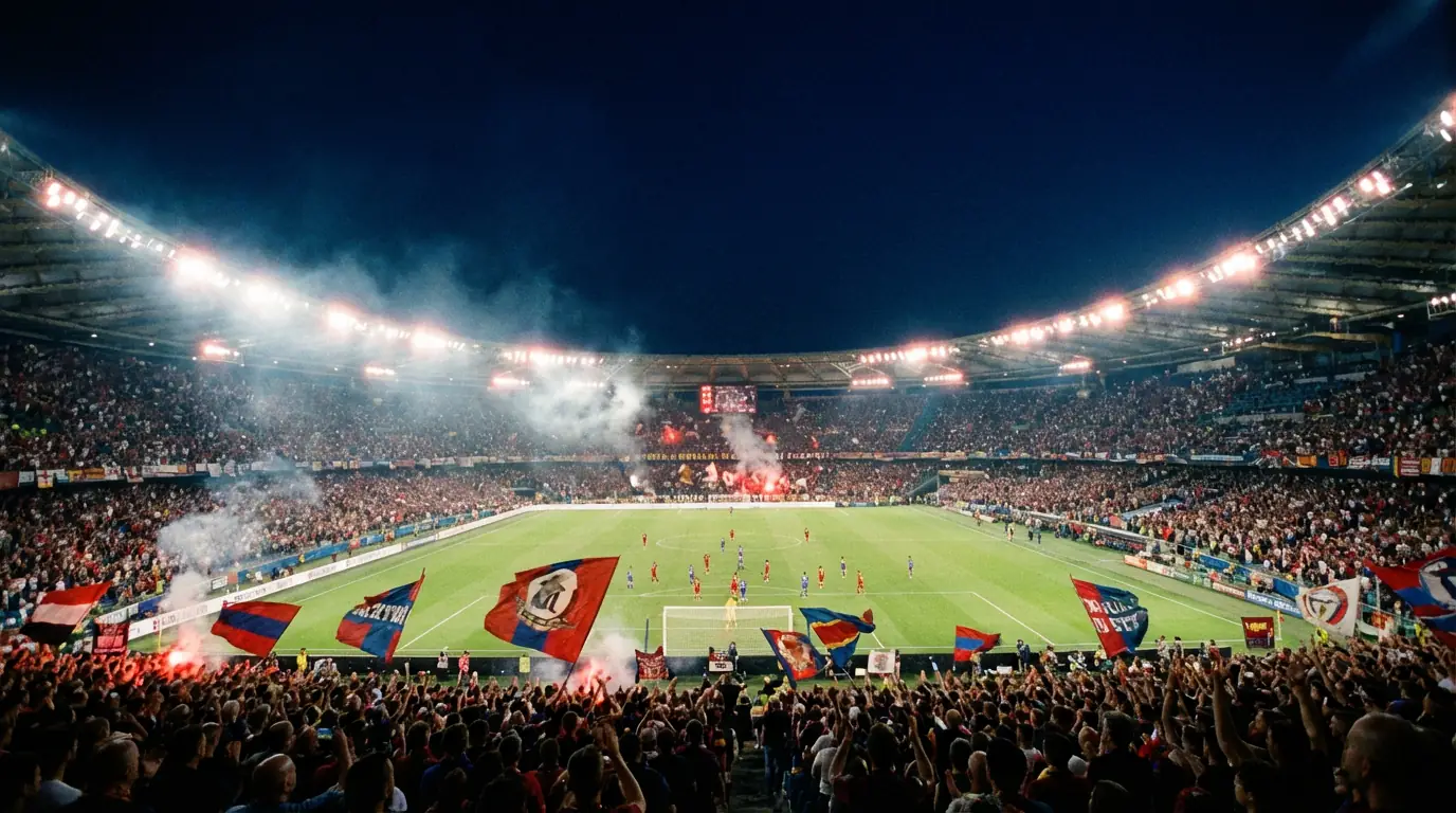 Stadio di calcio illuminato durante una partita notturna con tifosi sugli spalti